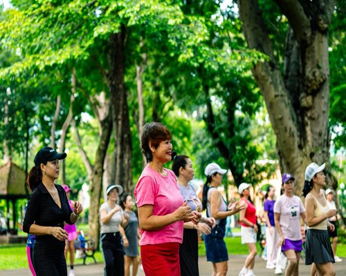 People walking peacefully in a local park enjoying fresh air