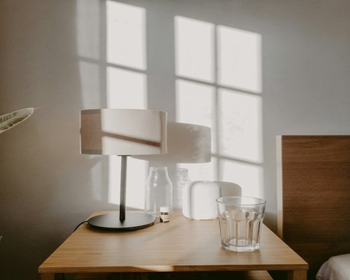 A glass of fresh water on a nightstand indicating hydration and rest